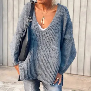 Close-up detail of oversized ribbed V-neck knit sweater in grey, cozy lazy pullover style.