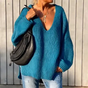 Chunky knit sweater detail, deep V-neck design, relaxed fit lifestyle shot view.