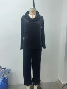 Detailed view of black velvet lounge set featuring cowl neck long sleeve top and loose pants.