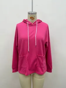 Close up of pink waffle knit hoodie, casual long sleeve sweatshirt with pockets and drawstring.