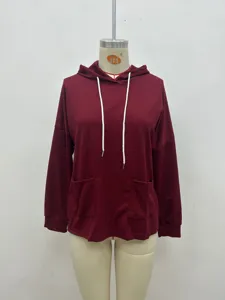 Burgundy waffle knit hoodie detail showcasing front pockets and white drawstrings.