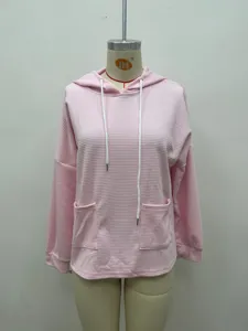 Pink waffle knit hoodie detail, long sleeves with adjustable white drawstring and front pockets.