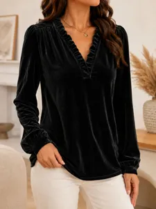 Blouse noire en velours à manches longues et col V pour femme, col à volants élégant et texture douce.