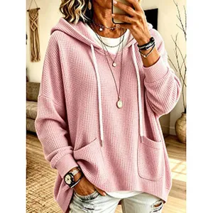 Casual waffle knit loose long sleeve hoodie for women with front pockets and adjustable drawstrings.