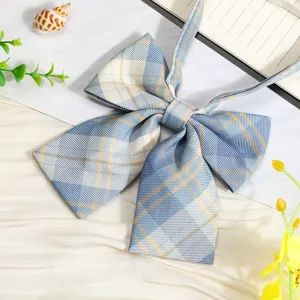 Detail view of a blue and yellow plaid JK uniform ribbon bowtie, cute sailor shirt accessory.