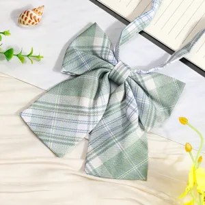 Green plaid JK bow tie detail shot, Japanese style school uniform ribbon accessory for shirt.