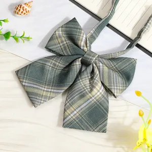 Close-up detail of green plaid JK uniform bow tie, elegant collar ribbon accessory.