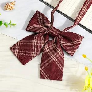 Close-up detail of wine red plaid JK ribbon bow tie, perfect for school uniform styling.