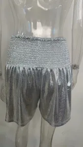 Silver shiny metallic shorts with high elastic smocked waistband for women, detail view.