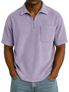 Close-up detail of men's short sleeve corduroy zipper polo shirt collar and chest pocket texture.