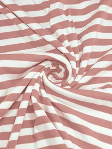 Pink and white striped ribbed fabric detail close-up, soft knit texture for apparel.