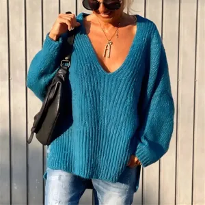 Detail shot of the cozy blue V-neck knit sweater, showcasing its soft coarse-knit ribbed texture.