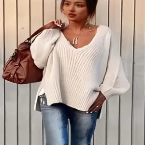 Casual women's solid color V-neck ribbed knit sweater, loose oversized pullover top.