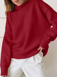 Close-up detail of solid color turtleneck long sleeve oversized sweatshirt comfortable fabric.