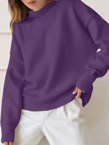 Close-up detail of a solid purple mock neck sweatshirt, comfortable loose fit and long sleeves.