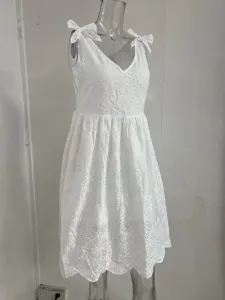 Vue détaillée d'une robe blanche sans manches en broderie anglaise avec nœuds.
