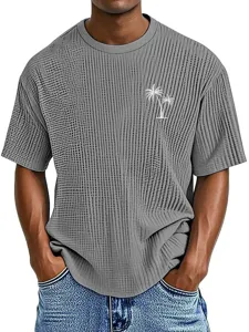 Detail view of men's casual waffle knit short sleeve t-shirt with tropical palm tree print.