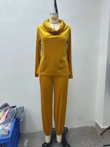 Detail view of mustard yellow velvet long sleeve top and pants lounge set on mannequin.
