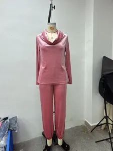 Pink velvet lounge set featuring a long sleeve cowl neck top and matching casual pants.