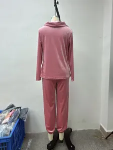 Back view detail of women pink velvet loungewear set featuring long sleeve top and pants.