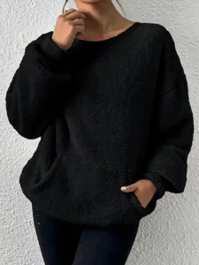 Close up detail of black fleece sweatshirt, soft textured fabric with front pocket design.