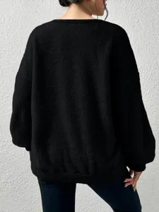 Detailed rear view of a cozy black fleece sweatshirt, soft plush texture, casual everyday wear.