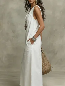 Detail view of the white sleeveless long dress, highlighting side pocket and loose linen style.