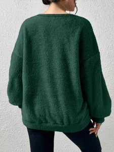 Back view detail of casual solid color long sleeve fleece sweatshirt in dark green textured fabric.