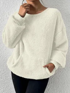 Close-up detail of women's cozy fleece crewneck sweatshirt pocket texture soft warm winter