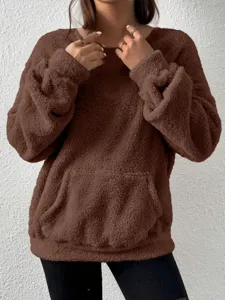Brown fuzzy sherpa fleece sweatshirt detail, cozy winter pullover with a front pocket style.