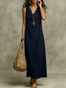 Detail view of the elegant navy blue sleeveless cowl neck dress, styled with accessories and bag.