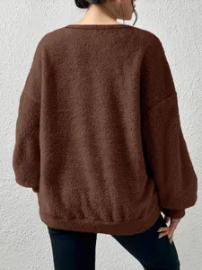 Solid brown fleece sweatshirt featuring long sleeves, cozy pullover design and soft fluffy texture.