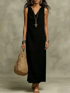 Detailed close-up view of women's casual black sleeveless summer maxi dress with stylish straw bag.