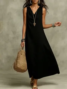 Close-up view of a stylish black sleeveless maxi dress styled with chic accessories and bag.