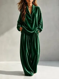 Close-up detail of dark green velvet long sleeve lapel top and wide leg trousers set.