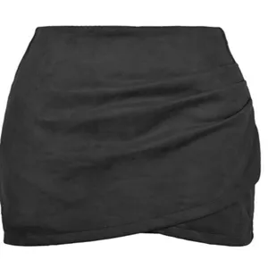 Details of black faux suede bodycon mini skirt with chic asymmetric draped design.