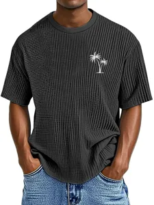 Close-up detail of men's waffle knit short sleeve t-shirt featuring palm tree print.