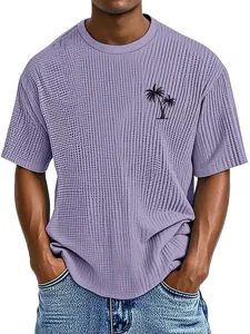 Detail shot of men's waffle knit t-shirt with tropical palm tree print, casual crew neck design.