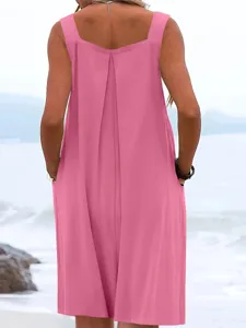 Detail view of the pink sleeveless wide leg jumpsuit showing back pleated design.