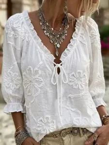 White boho embroidered V-neck blouse with 3/4 sleeves and chic front tie detailing for women.
