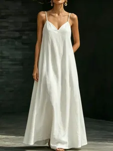 White V-neck slip maxi dress detail shot, featuring flowing hem and lightweight fabric.
