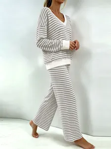 Close up detail of striped V-neck long sleeve top and matching wide leg lounge pants.