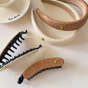 Woven braided hair band and banana clip set featuring elegant gold metal plaque details.