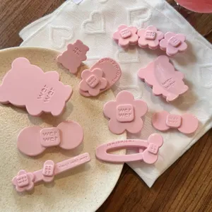 Cute pink acetate hair clips set featuring floral and bow designs for sweet styling.