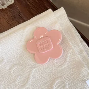 Pink flower hair clip detail shot, elegant side hairpin and sweet accessory design style.