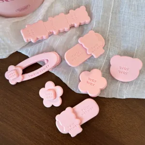 Cute pink hair clips set featuring bear and flower designs for sweet daily styling and fashion.