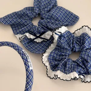Detailed view of blue plaid hair scrunchies with lace trim and cute ribbon bow decoration.