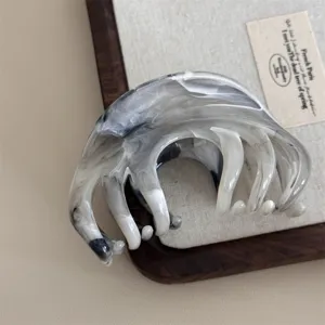 Vintage marbled hair claw clip for women, elegant black and white acetate hair accessory.