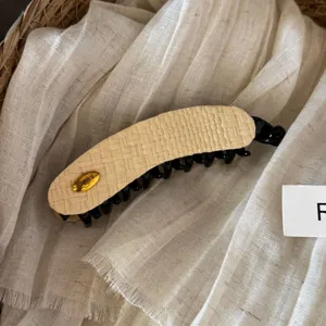 Woven straw banana hair clip with elegant gold metal buckle for chic ponytail and bun styling.