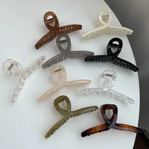 Detailed view of minimal twisted hair claw clips set in various morandi and clear colors.
